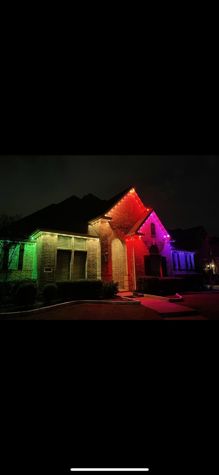 Home illuminated in green, red, pink, and blue by Govee permanent lighting